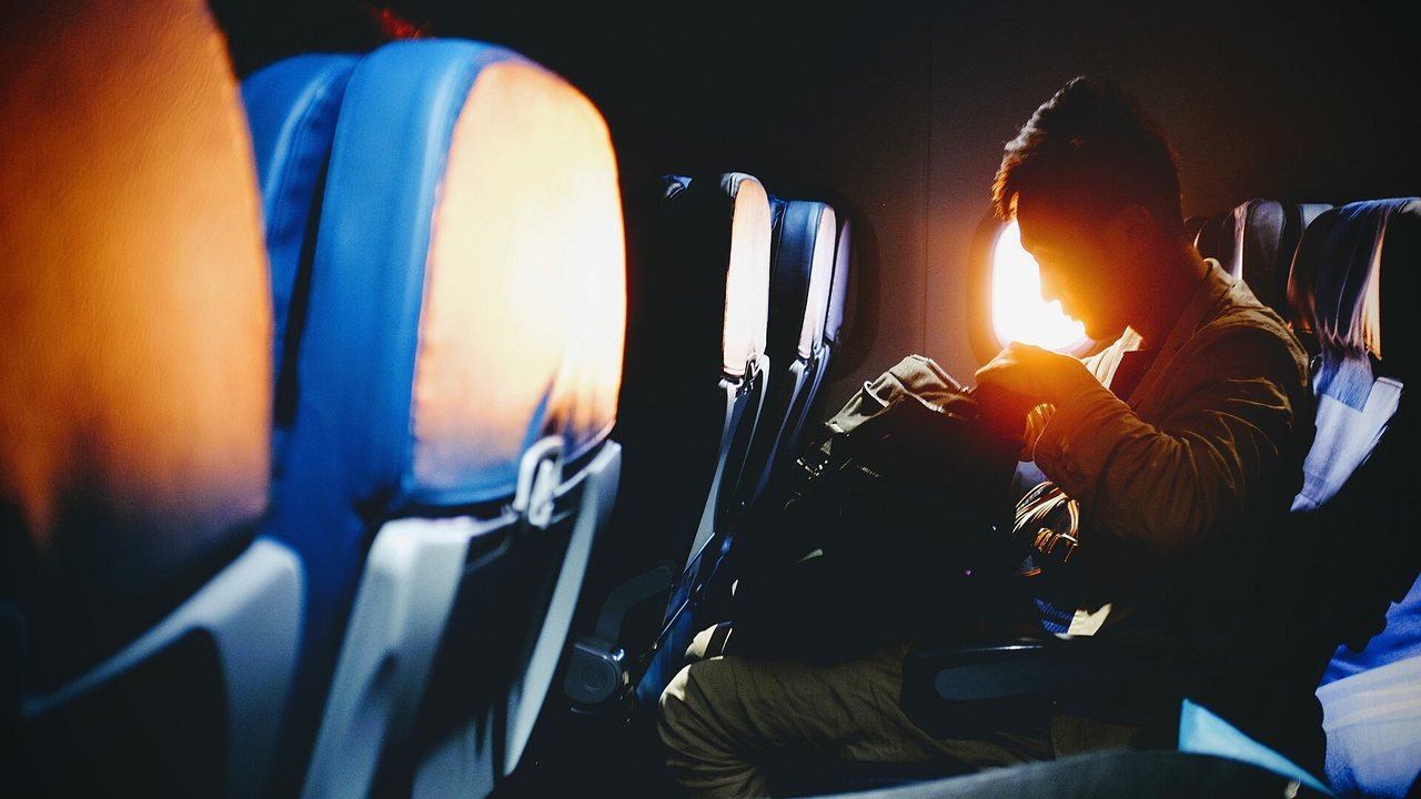 Stand-in, not a photo of either flight: a passenger’s view through an airliner cabin window of a wing over clouds and sea, June 2017
