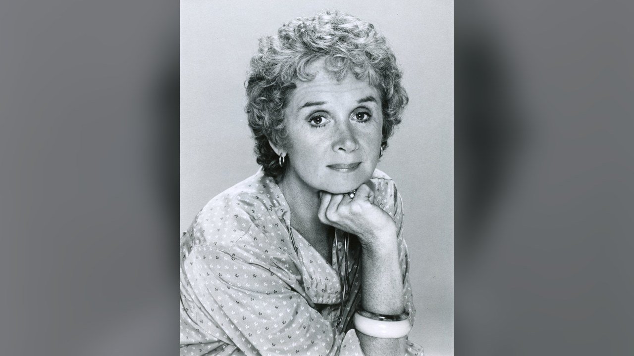 Black-and-white 1980 ABC press portrait of Barbara Barrie, short curly hair, chin resting on one hand, wearing a patterned blouse and a white bangle, set against a soft gray background; an archival publicity photo, not a recent image