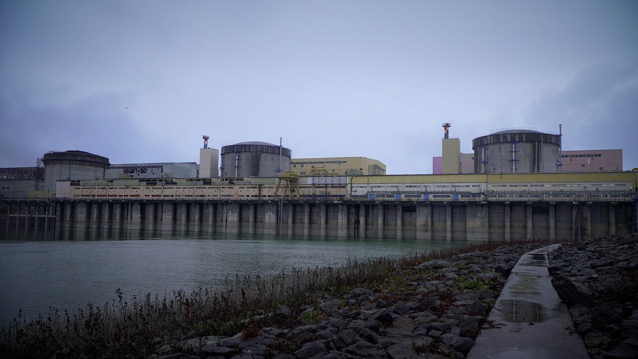 Stand-in: December 2024 IAEA photo of Romania's Cernavodă nuclear plant seen across the water, not a photo of the shutdown