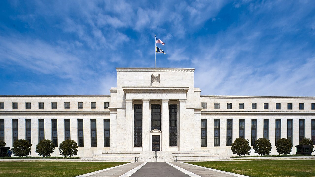 Stand-in, not a photo of Wednesday: the Federal Reserve’s Marriner S. Eccles Building in Washington under a blue sky, with the U.S. flag flying above it, in a March 2011 Federal Reserve photo