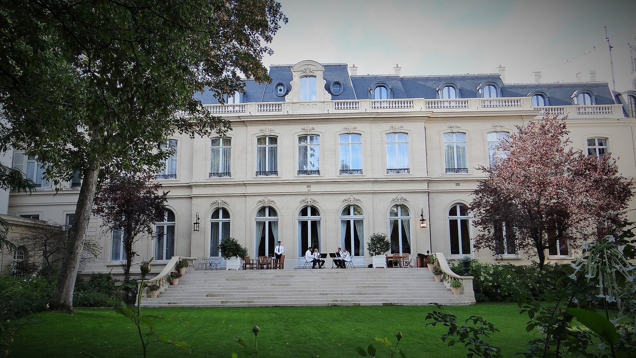 Stand-in, not a photo of this event: September 2018 photo of the garden front of the Hôtel de Beauvau in Paris, home of France’s Interior Ministry, a pale stone building with tall windows and a slate mansard roof, with stone steps, a lawn and trees in front