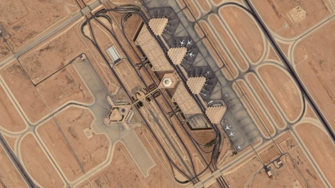 Archival stand-in: 2006 satellite image of Riyadh’s King Khalid International Airport, showing runways, taxiways and the terminal complex in tan desert