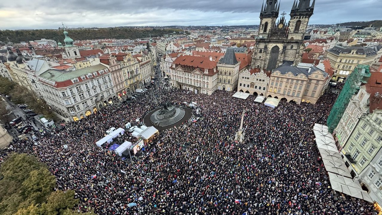 Thousands of demonstrators holding Czech flags gather around the Jan Hus Memorial in front of the Church of Our Lady before Týn in Prague’s Old Town Square on Sunday, Oct. 25, 2026, during the rally against scrapping public media licence fees