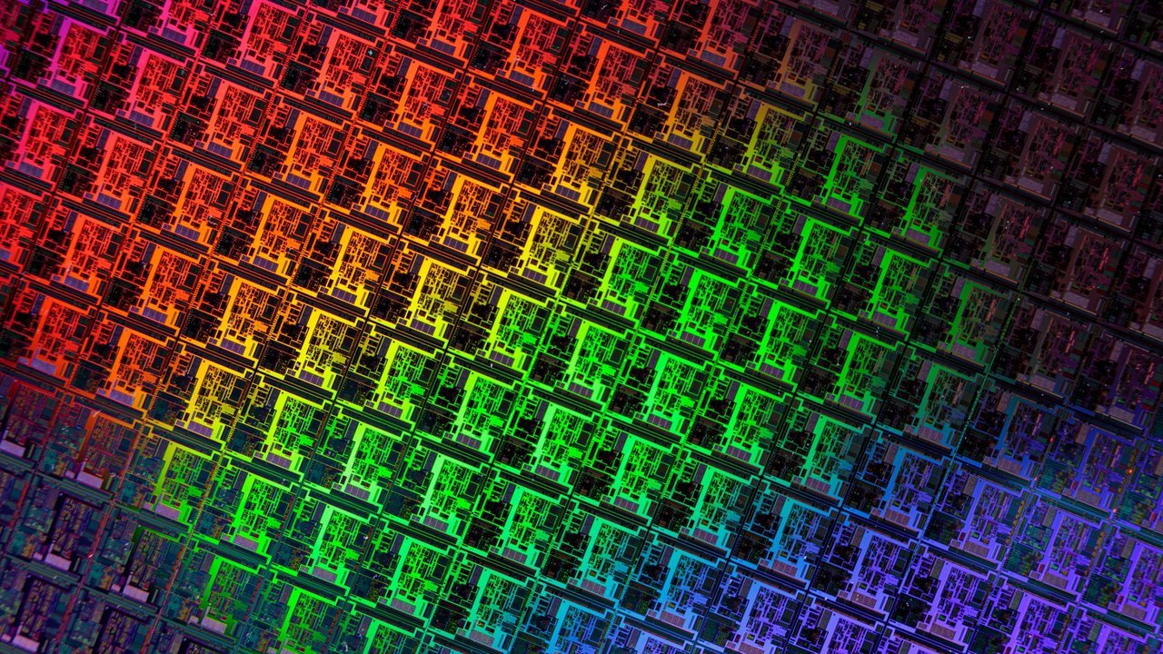 Stand-in, not a photo of this event: rows of chip dies on a silicon wafer catch light in a red, green and blue gradient, in a 2020 close-up