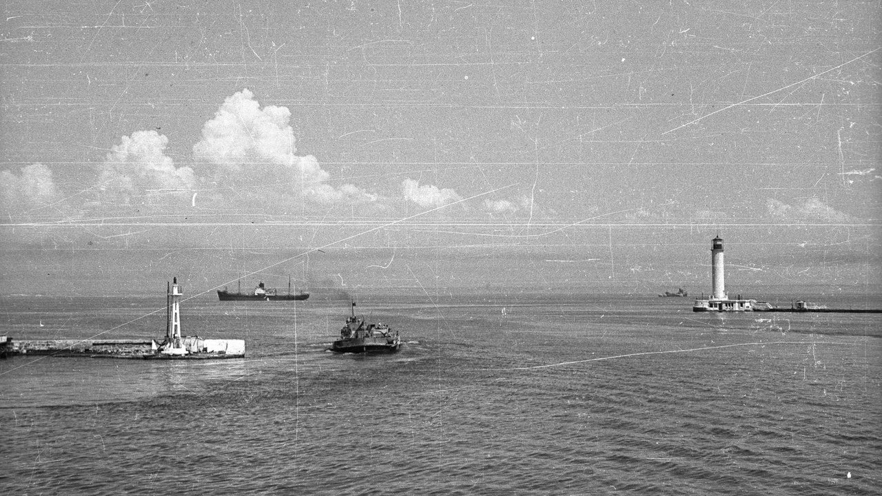 Stand-in, not a photo of this event: archival 1962 view of the Sulina Branch mouth of the Danube Delta meeting the Black Sea, with a lighthouse and coastal structures at Sulina, Romania